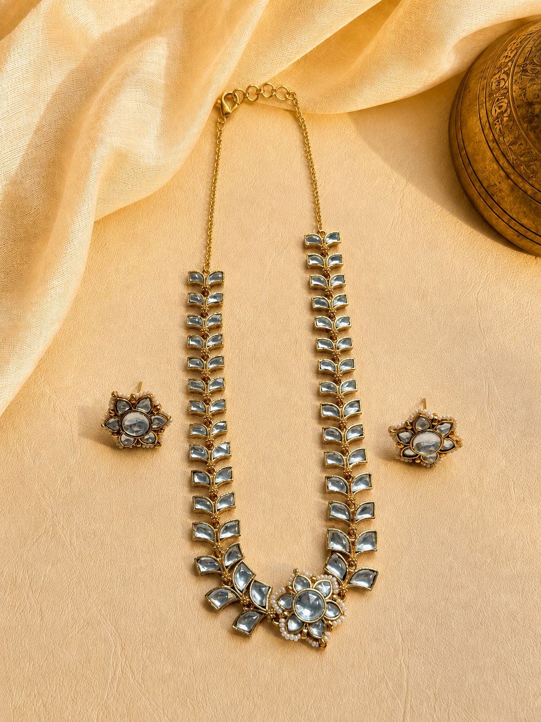 Clear stone leaf motif necklace set with floral stud earrings