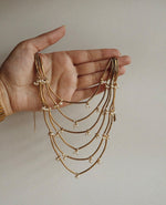 Load image into Gallery viewer, Graduated Draped Strands with Delicate Bead Accents
